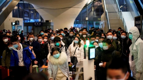 People-wearing-face-masks-arrive-at-a-railway-station-in-Wuhan-on-the-first-day-of-inbound-train-services-resumed-following-the-novel-coronavirus-disease-COVID-19-outbreak.JPG